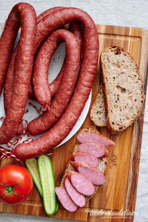 Sliced kielbasa with sourdough bread and vegetables. 