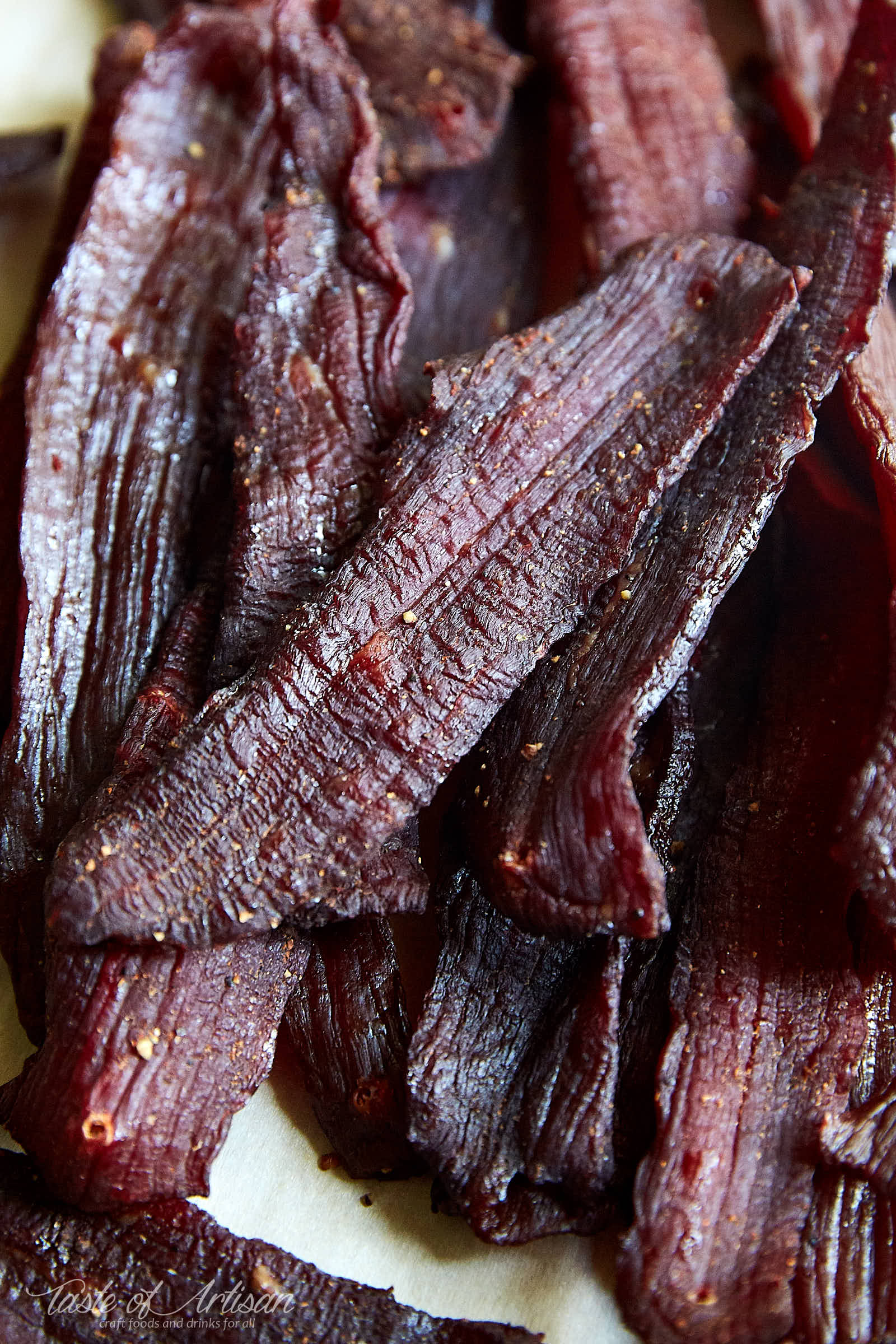 A pile of beef jerky on a table.