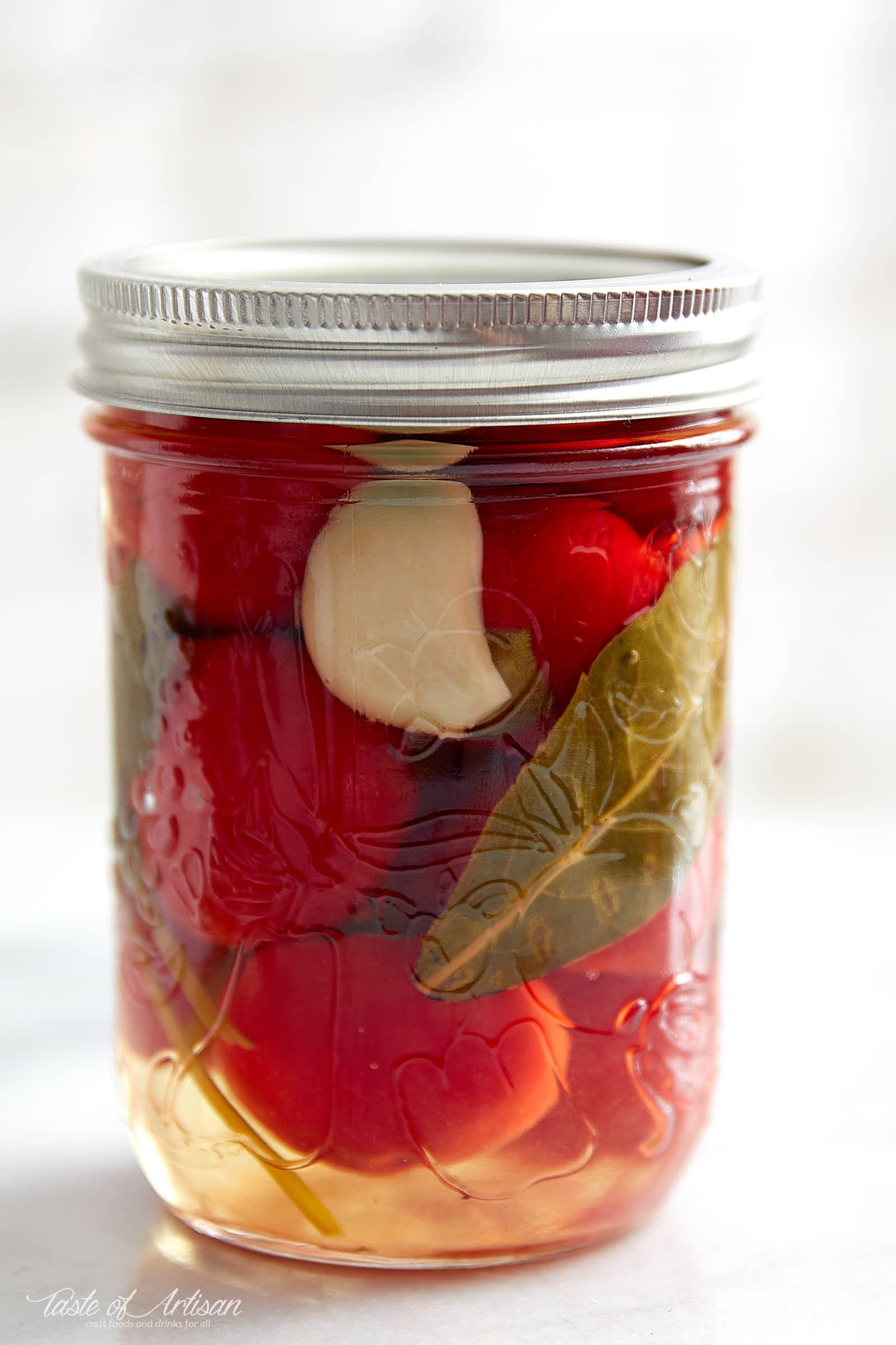Cherry pepper pickled in a savory, with just a touch of sweetness, pickling liquid. These pickled cherry peppers are excellent with grilled and other meats. | Taste of Artisan