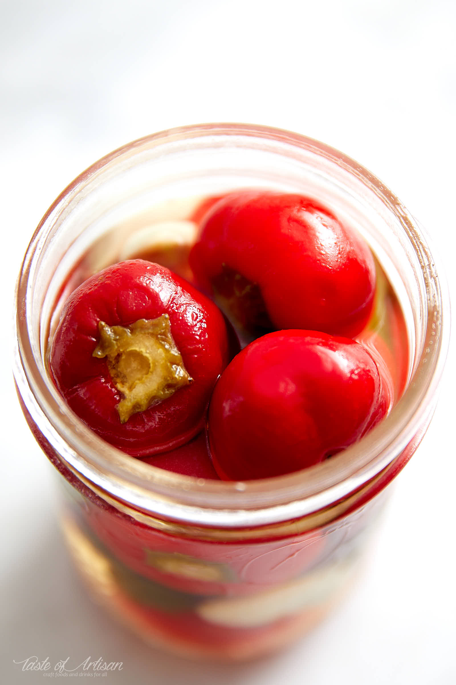 Cherry pepper pickled in a savory, with just a touch of sweetness, pickling liquid. These pickled cherry peppers are excellent with grilled and other meats. | Taste of Artisan