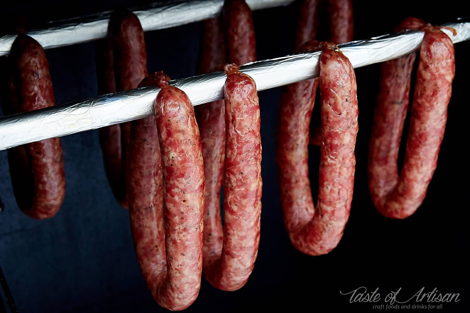 https://tasteofartisan.com/wp-content/uploads/2019/01/Swojska-Polish-Kielbasa-Sausage-Inside-Masterbuilt-Smoker-Smoking.jpg