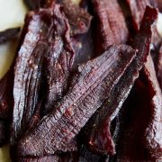 A pile of beef jerky on a table.