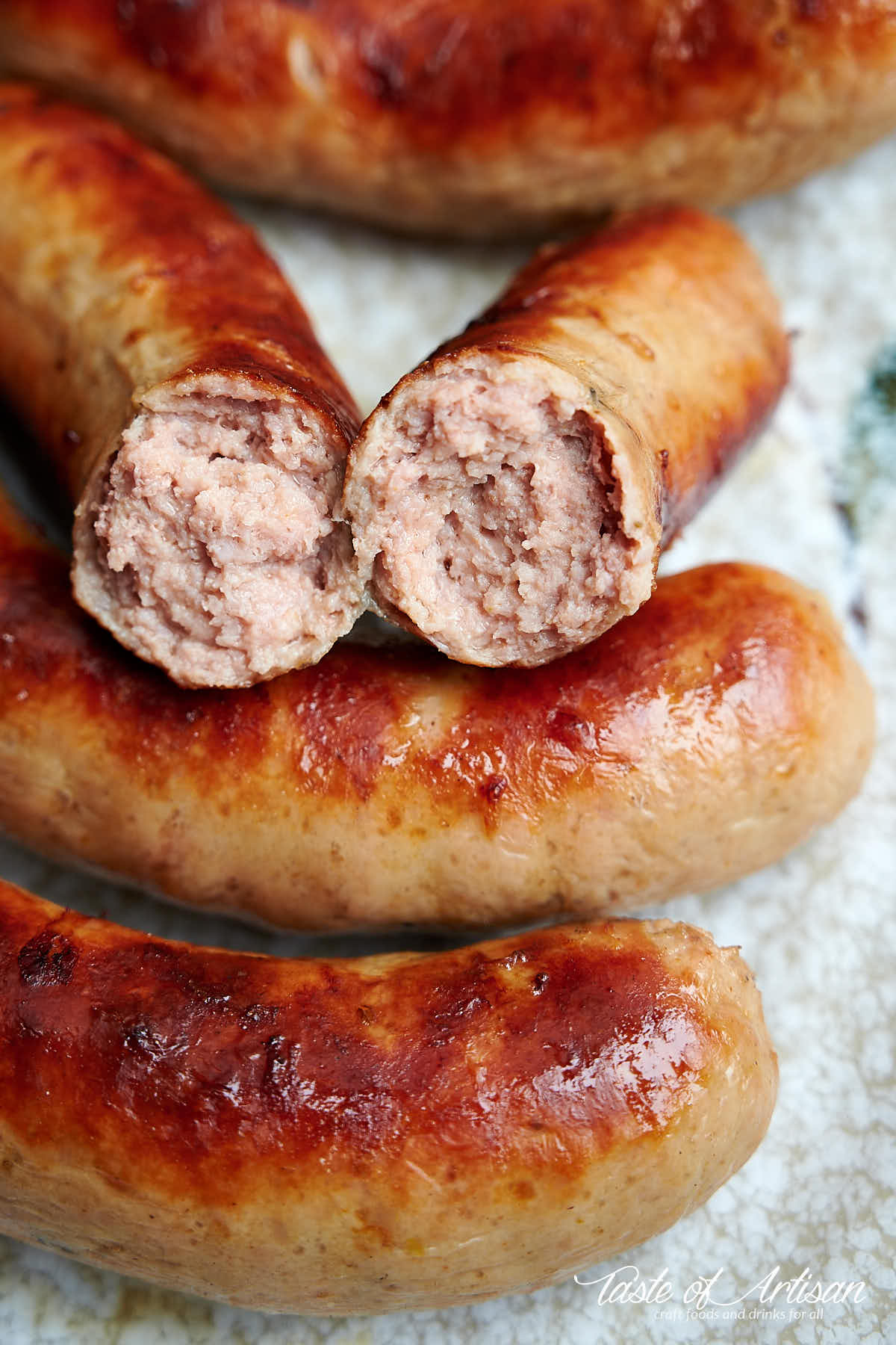 Close up of Bockwurst sausages with one split in half.