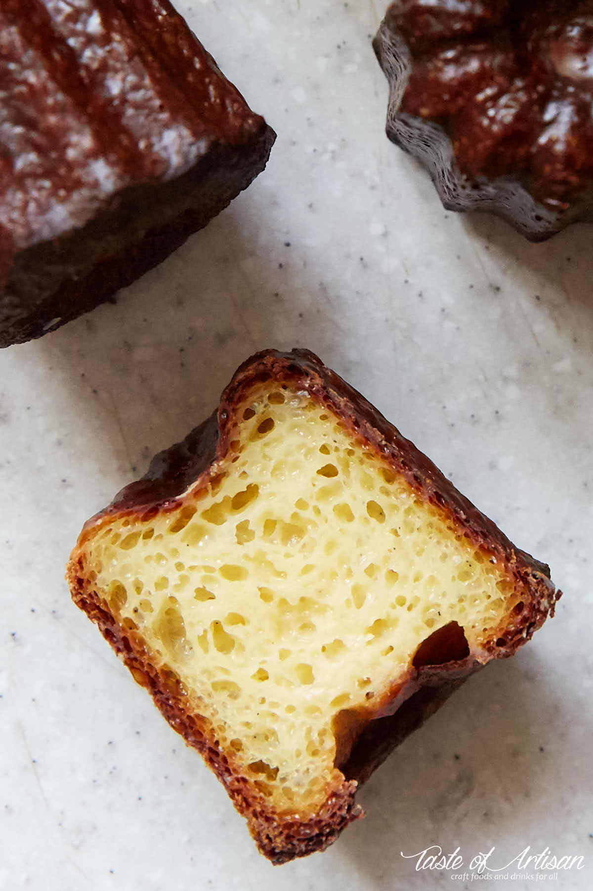 Canele, cut in half, custard interior, moist and tender.