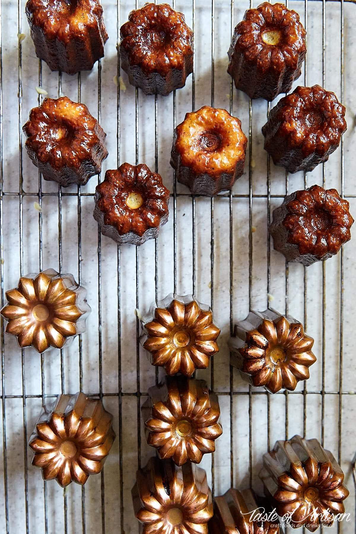 Caneles on a cooling rack after baking.