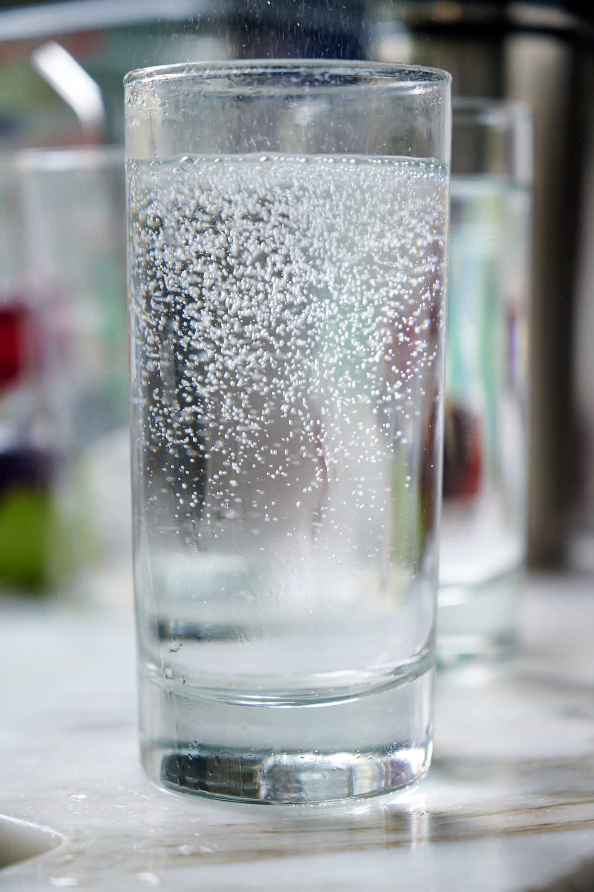Glass of fizzy homemade carbonated water on a table