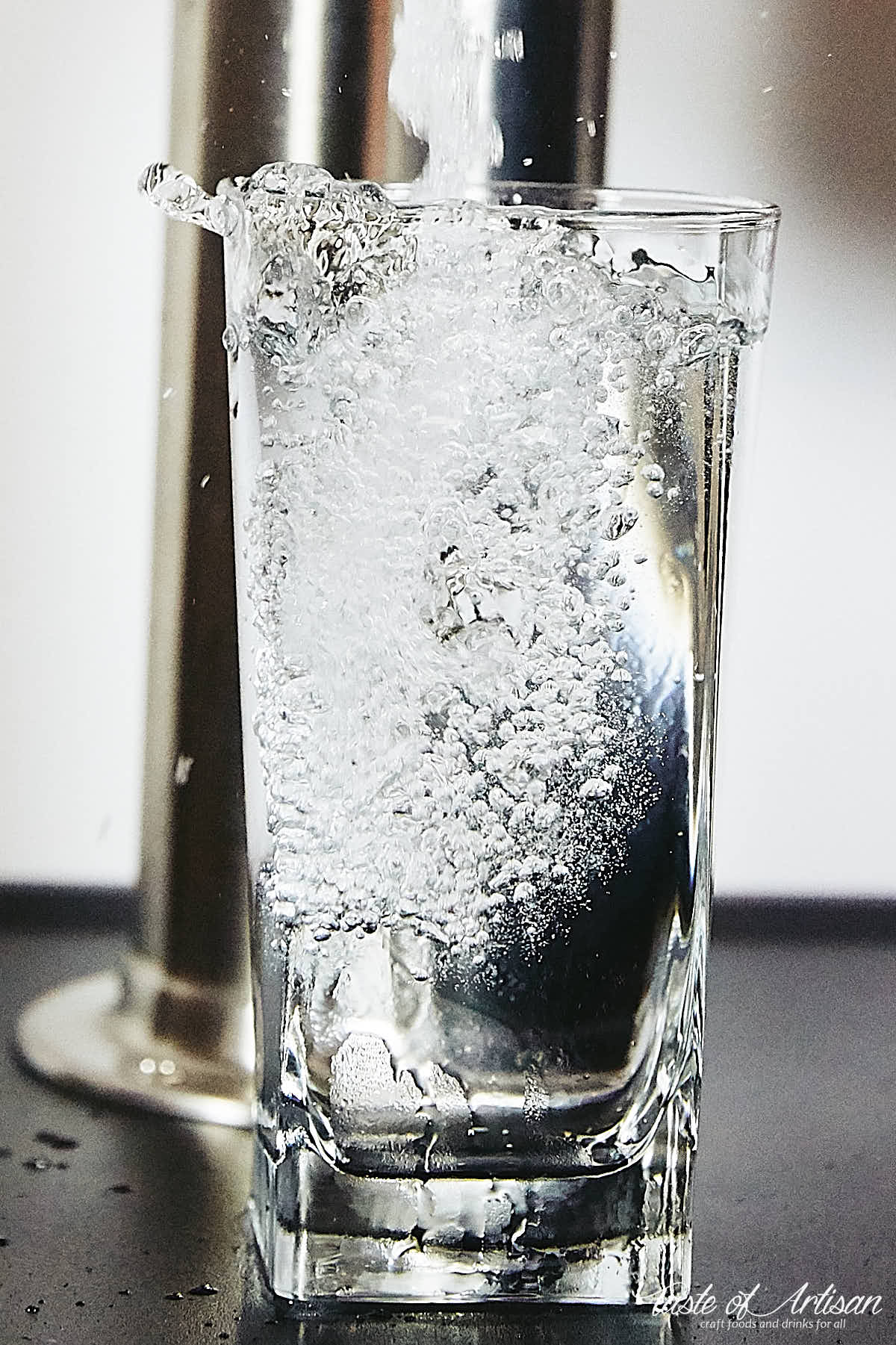 Home carbonated water poured in glass