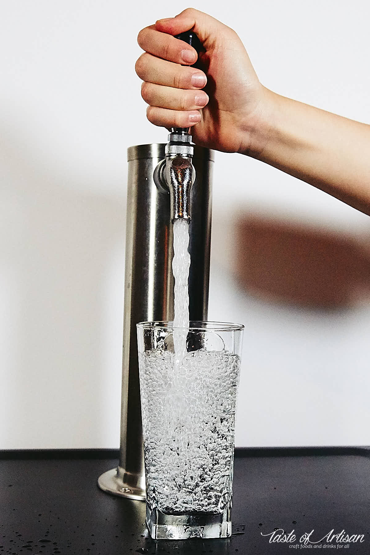 Pouring carbonated water in a glass.