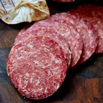 Slices of salami Milano on a cutting board.