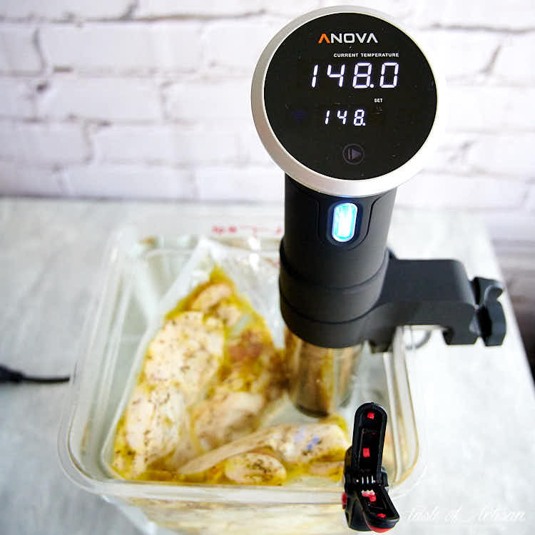 Sous Vide chicken cooking temperature shown on sous vide machine.