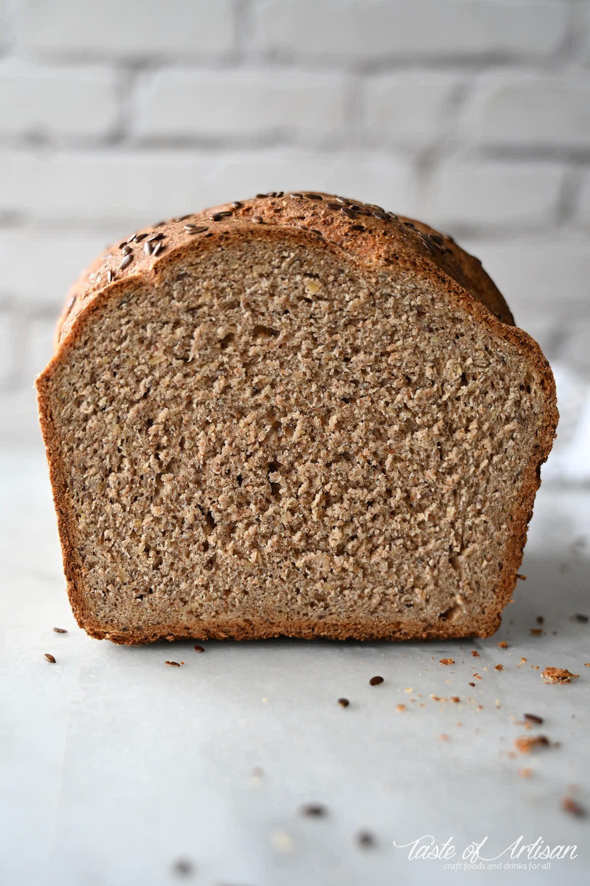 Flaxseed bread loaf cut in half, view of crumb.