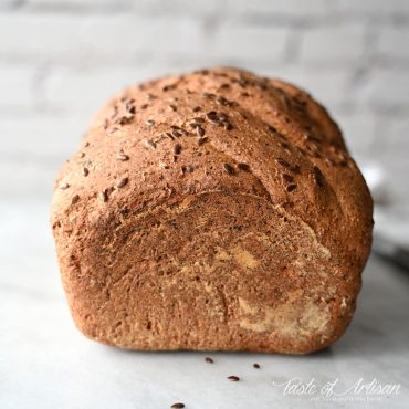 Flaxseed bread on a white marble board.