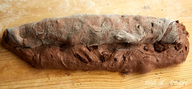 Rolling chocolate baguette dough.