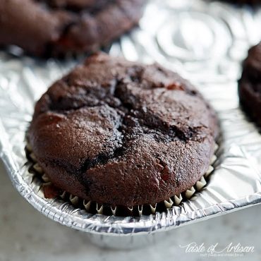 Chocolate cherry cupcake in a muffin pan.