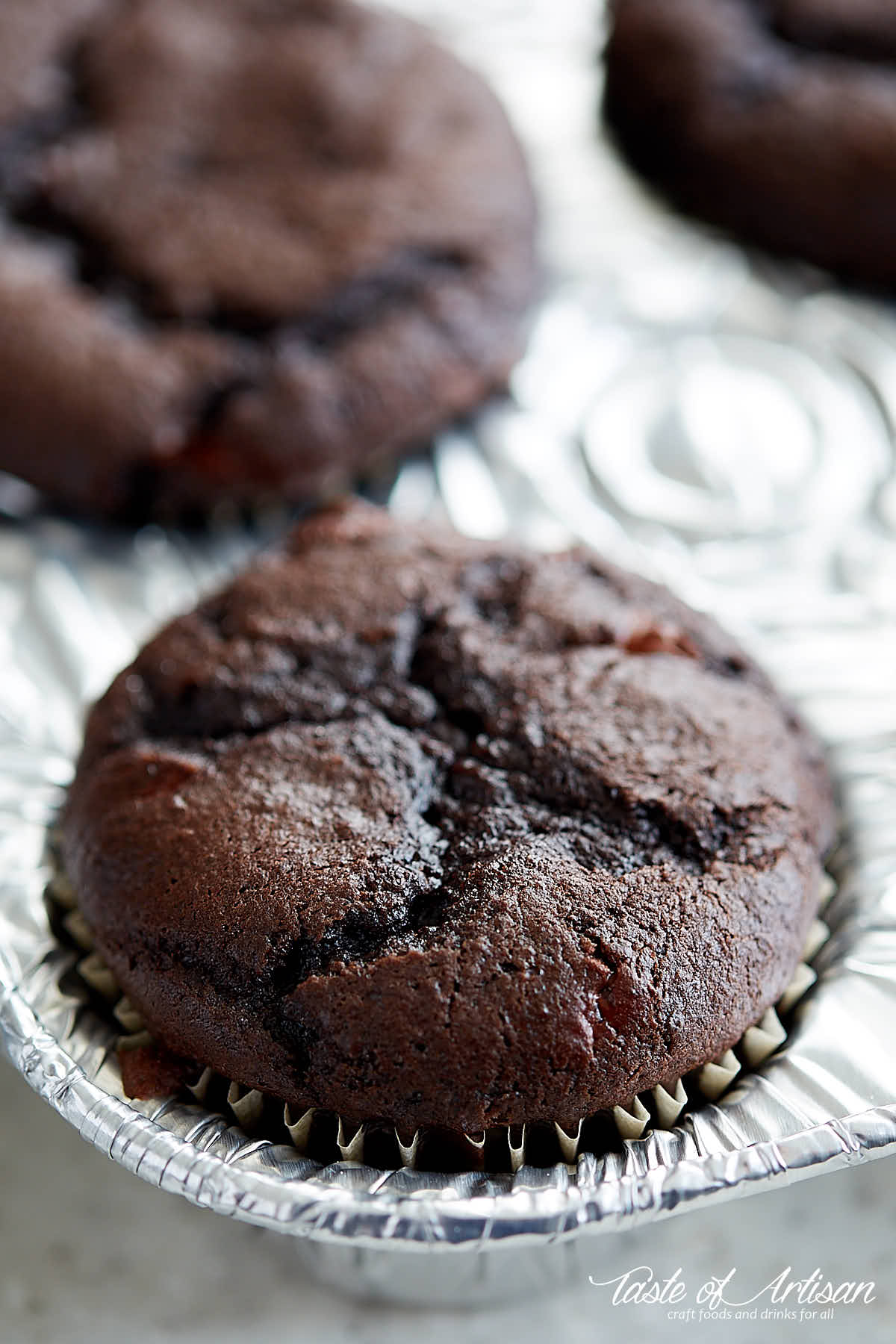 Chocolate cherry cupcake in a muffin pan.