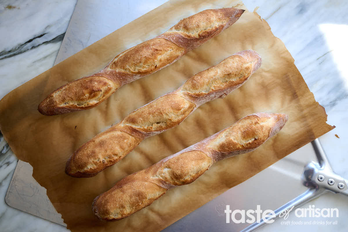 French baguettes baked on parchment paper.