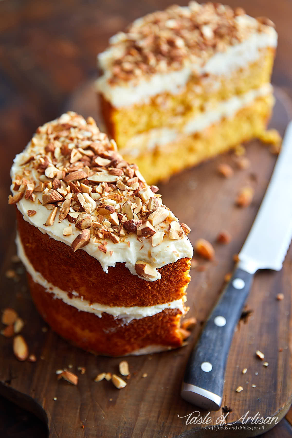 Gluten free carrot cake with cream cheese frosting cut in half.