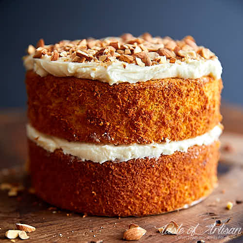 Full carrot cake on a cutting board.