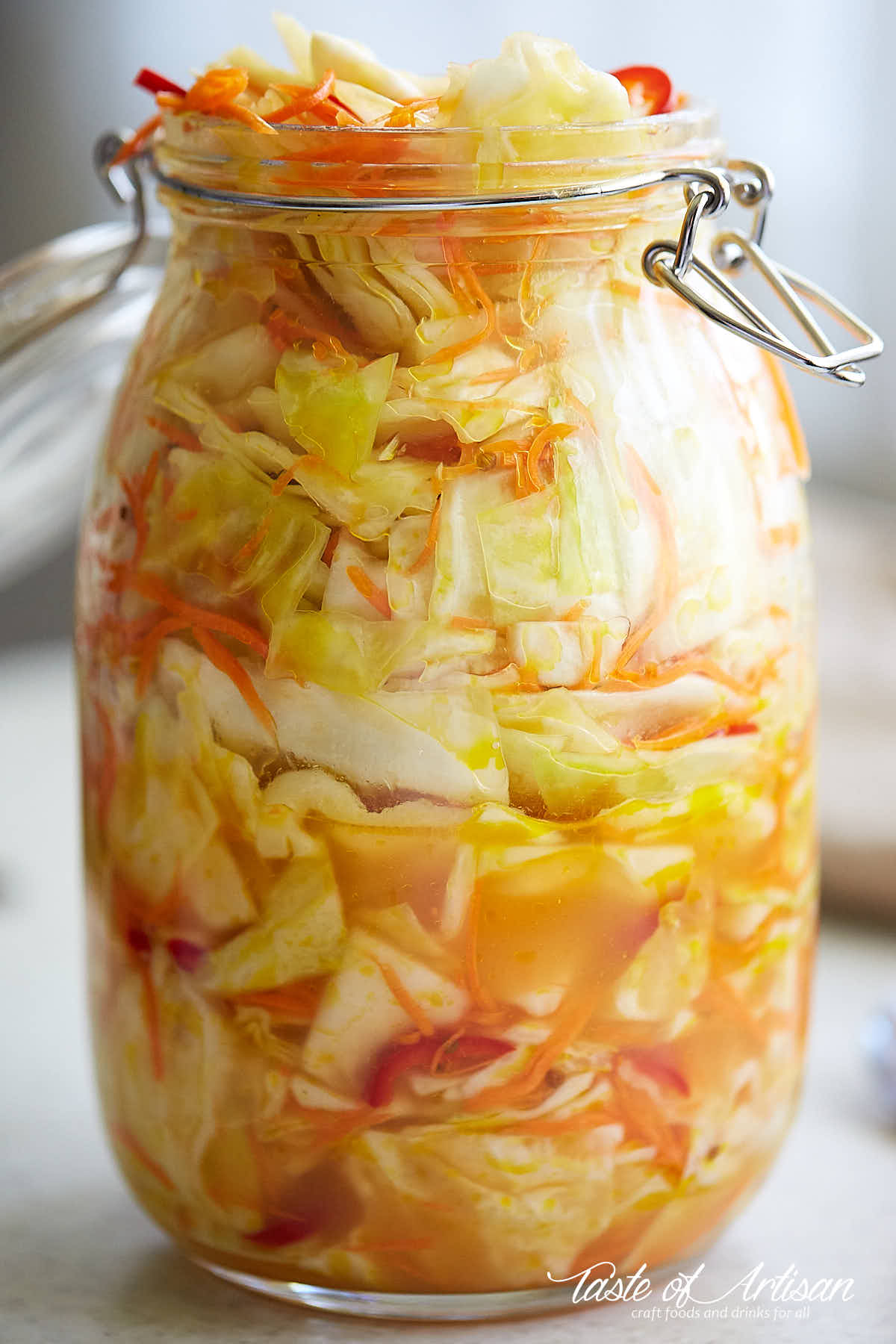 Pickled cabbage in a large glass jar.