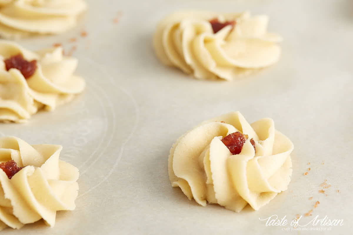 Shaped shortbread cookies with jam piped in the center.