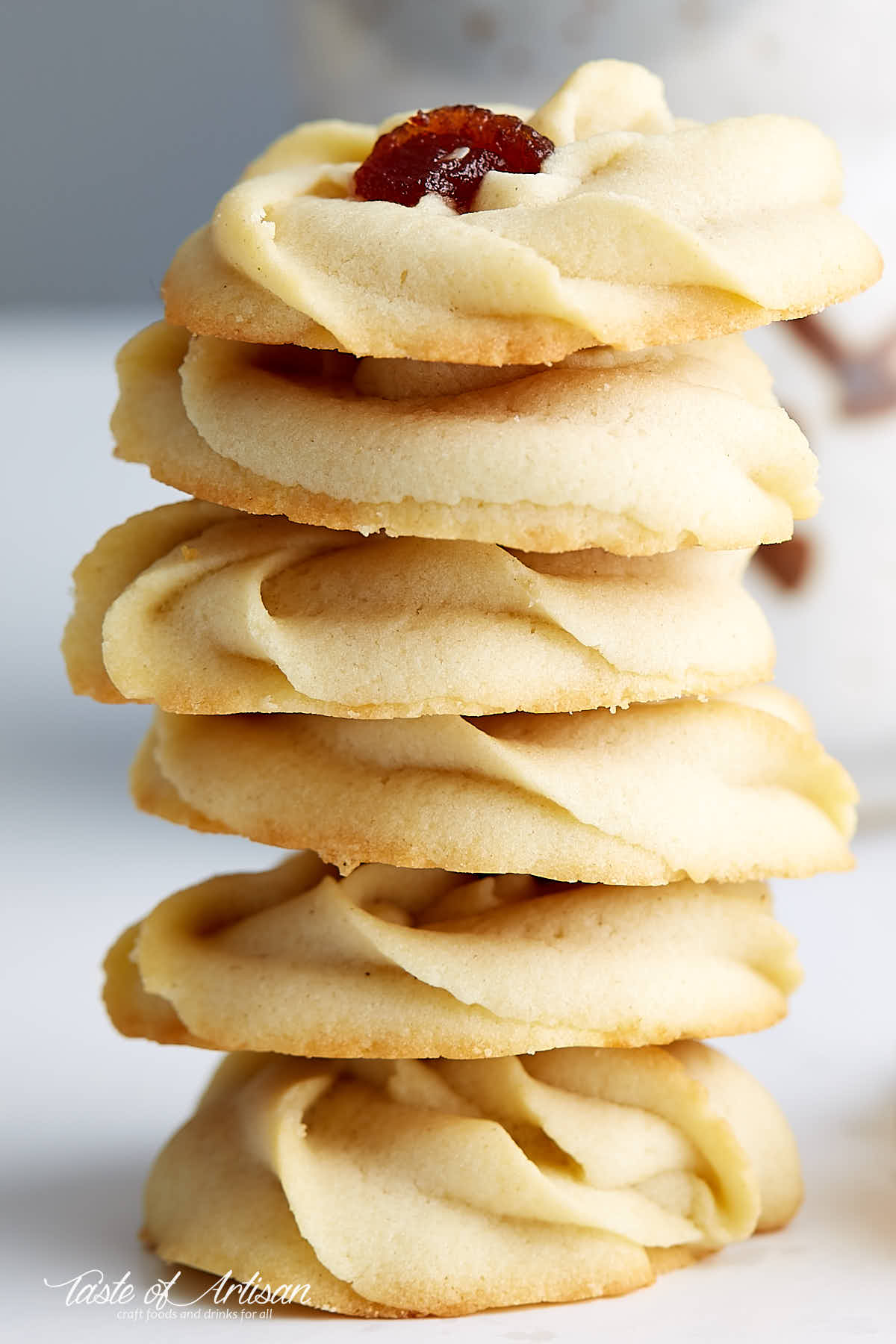 A stack of shortbread cookies with jam.