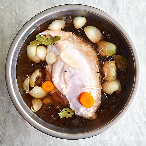 Raw turkey breast inside brine before smoking.