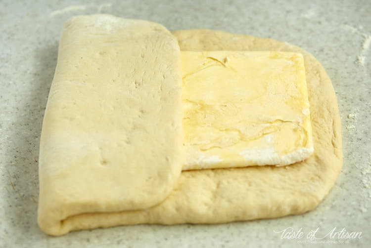 Dough folded over butter rectangle laminating for croissants.