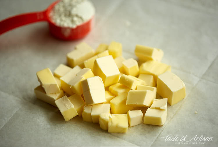 Cubed butter on a piece of parchment paper.