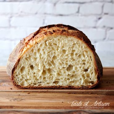 Half loaf of easy to make no knead bread on a cutting board.