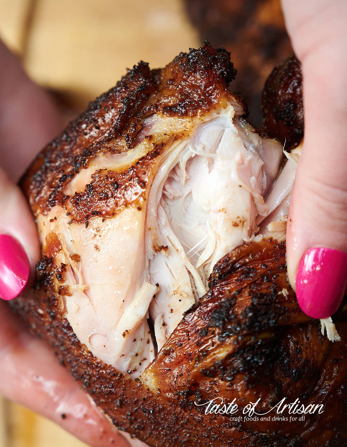 Splitting open juicy, tender smoked chicken quarter.