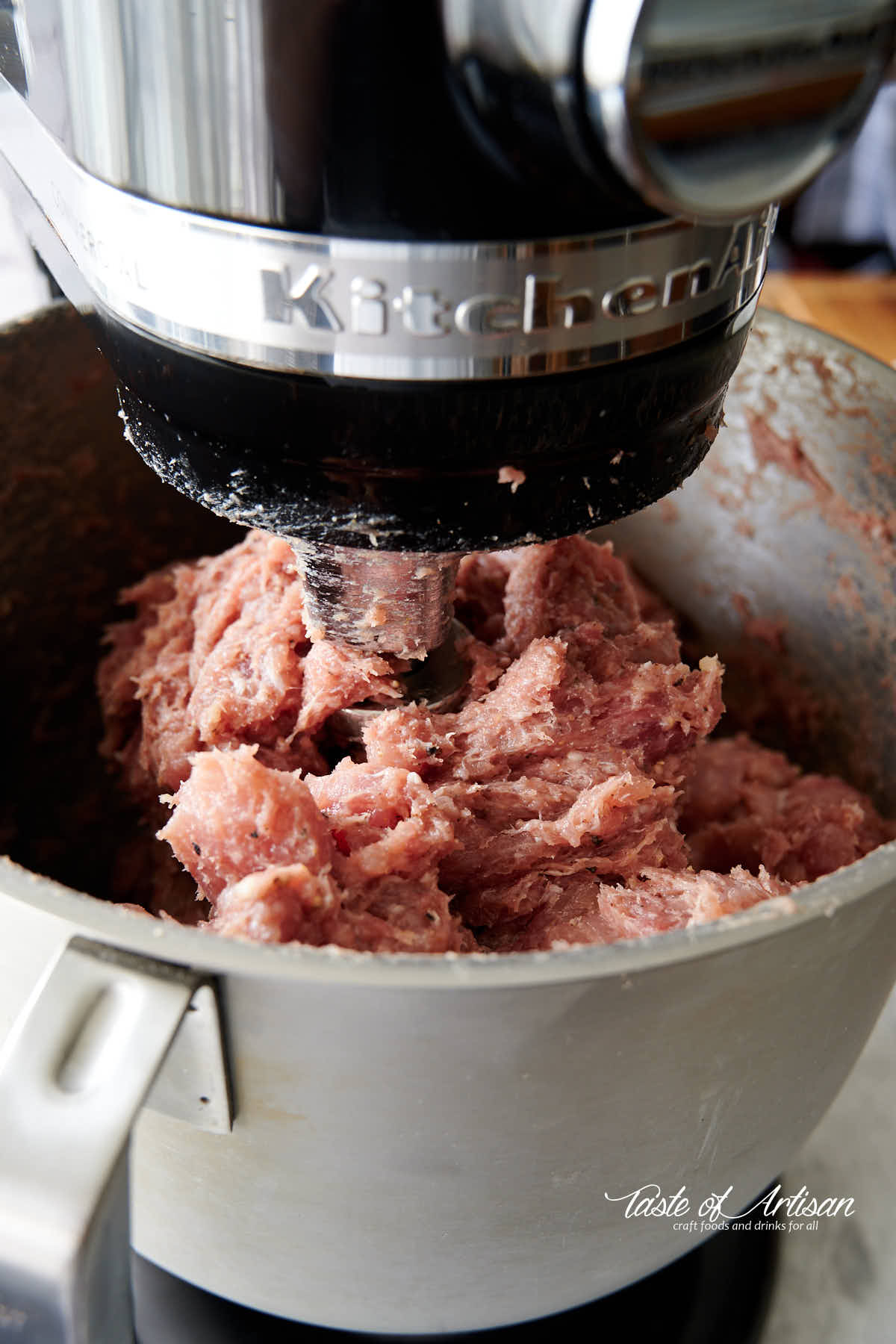 Mixing meat for smoked kielbasa in a stand mixer with paddle attachment. 