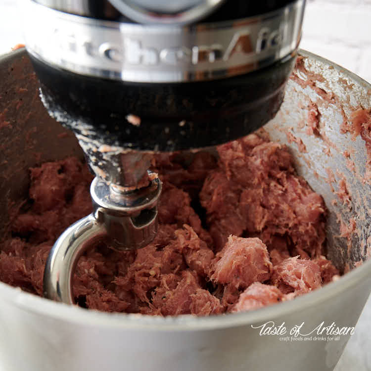 Mixing meat for smoked kielbasa in a stand mixer with dough hook.. 
