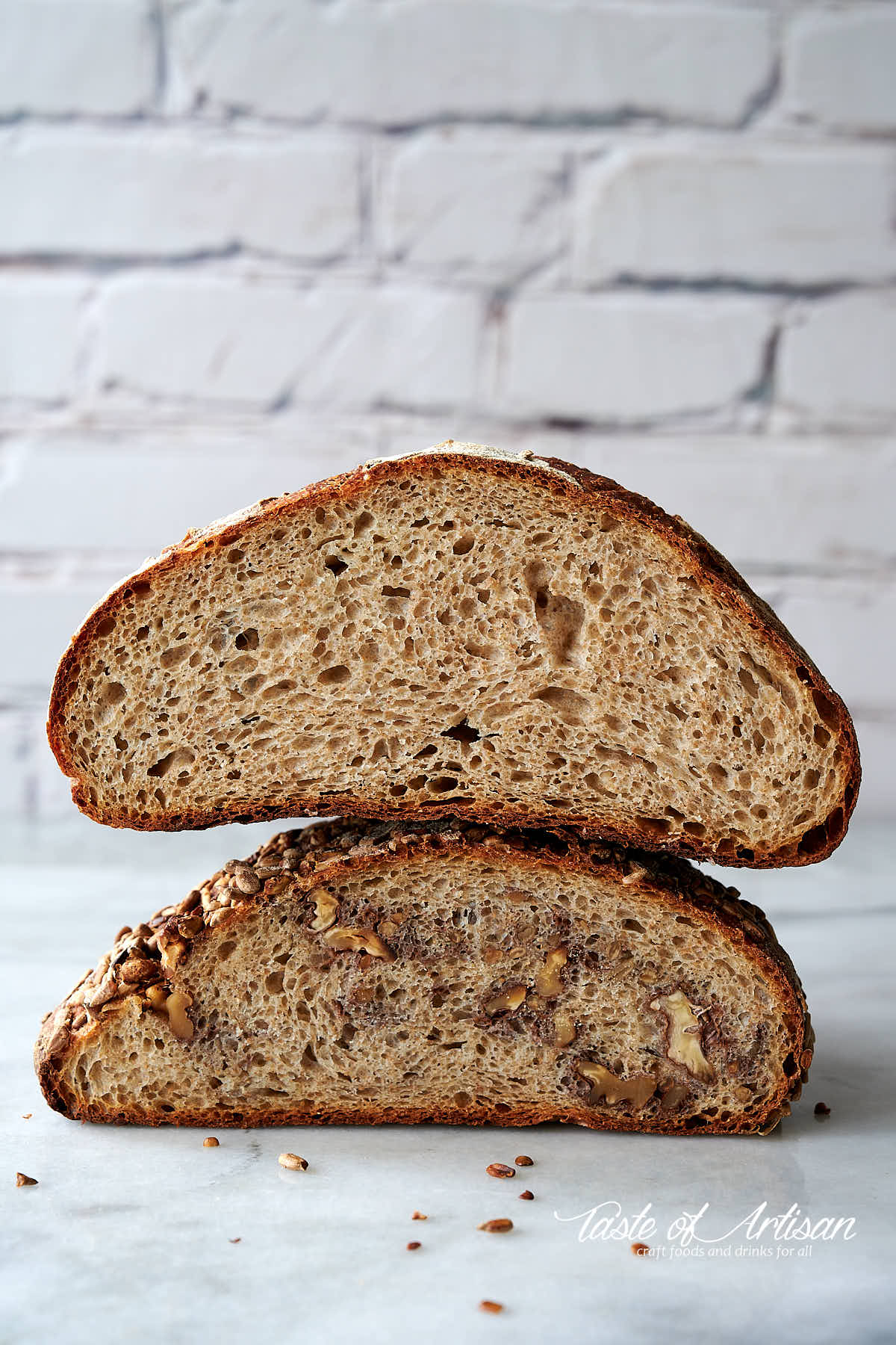 Whole what and rye no knead bread loaves on a marble table.