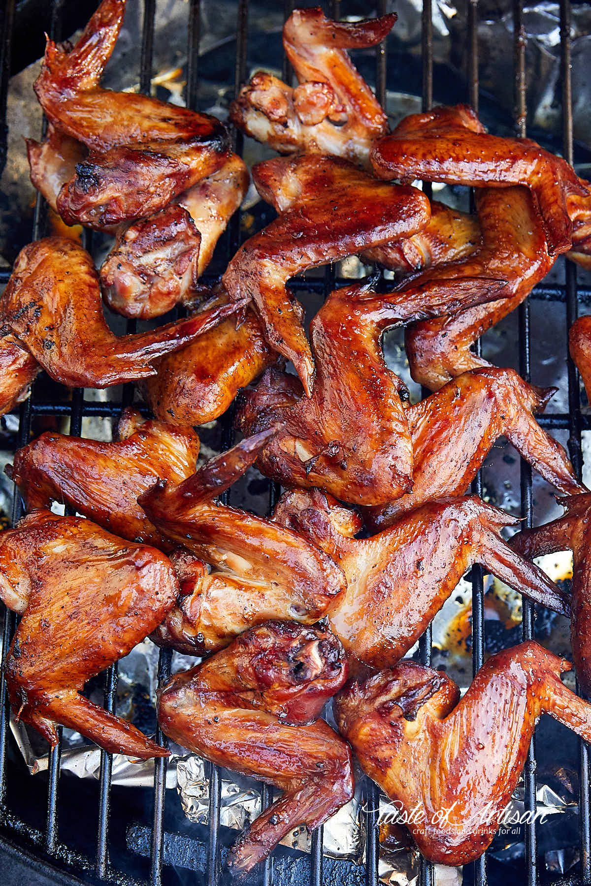 Chicken wings on the rack of a smoker.