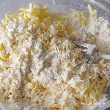 Mixing grated butter with the flour mix.