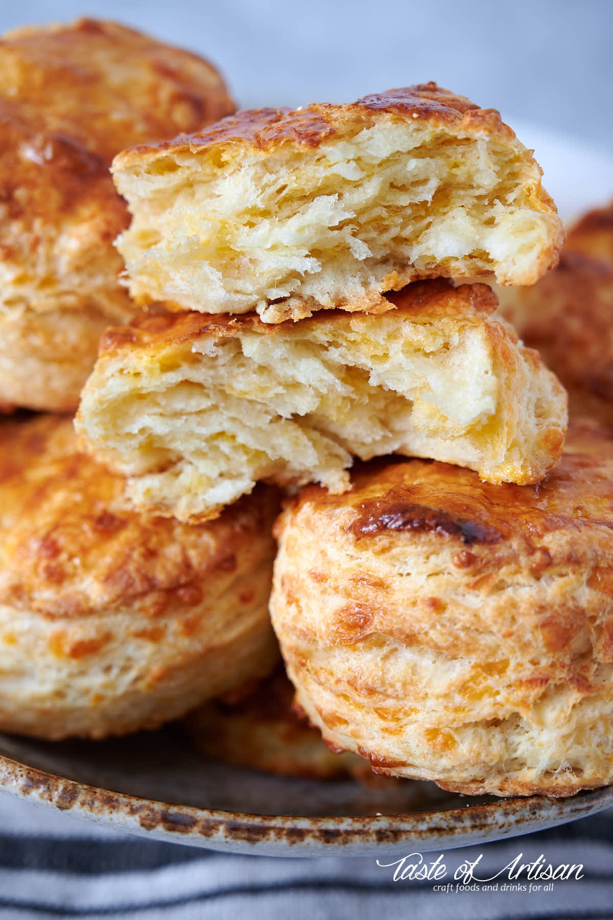 Close up of flaky, buttery soft biscuit cut in half.