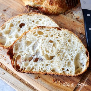 Slices of no -knead sourdough bread on a cutting board.