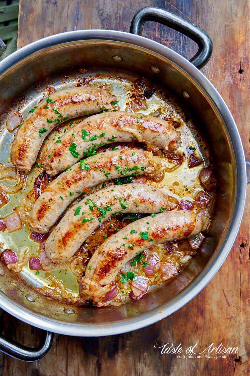 Italian sausages fried in a pan.