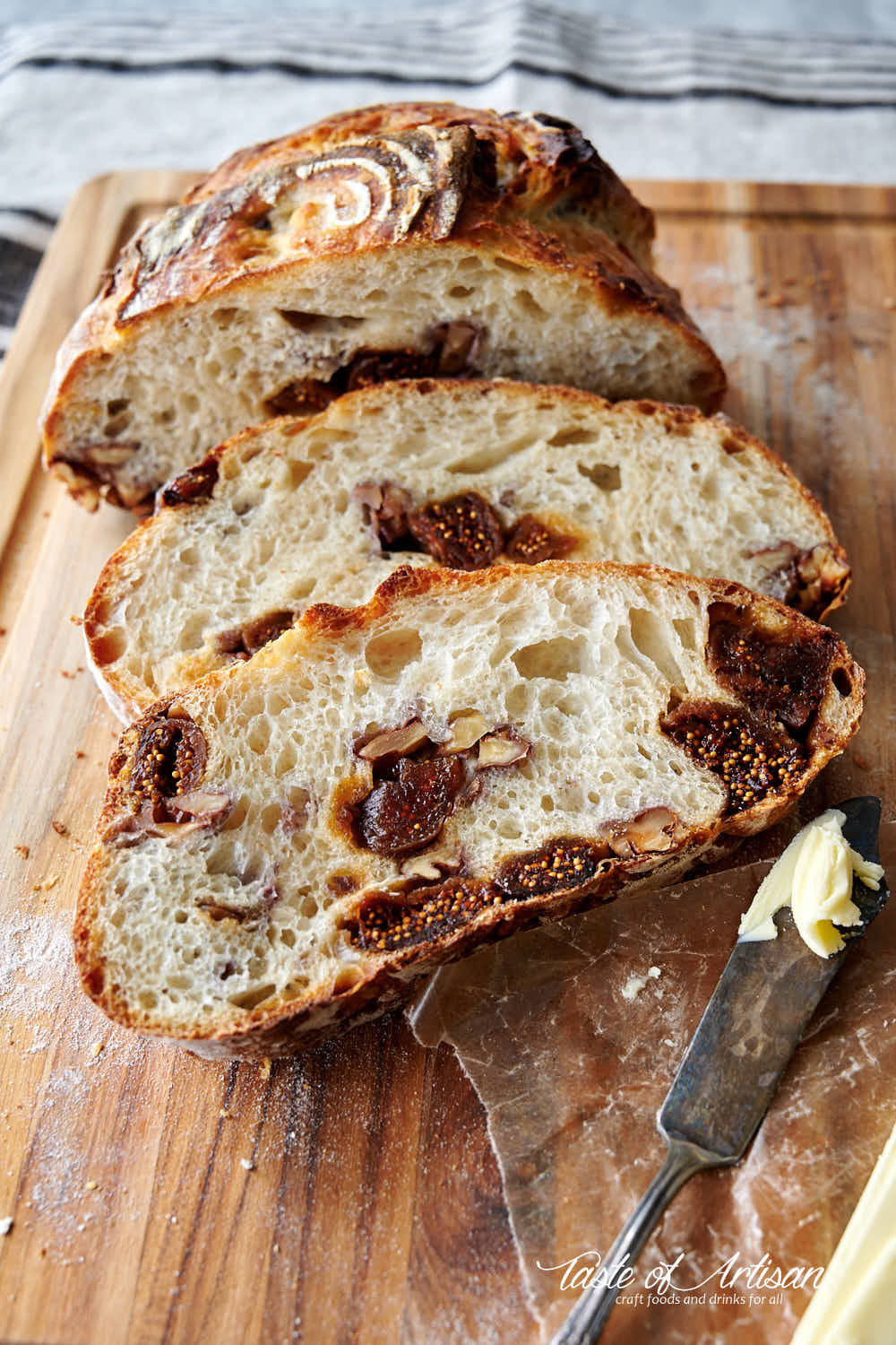 Close u p of slices of sourdough bread with chopped walnuts and quartered dates mixed in.