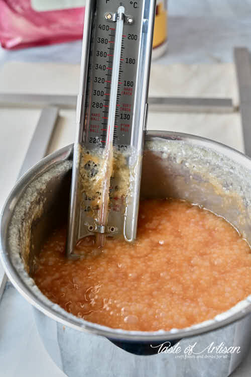 Caramel in a pot with thermometer.