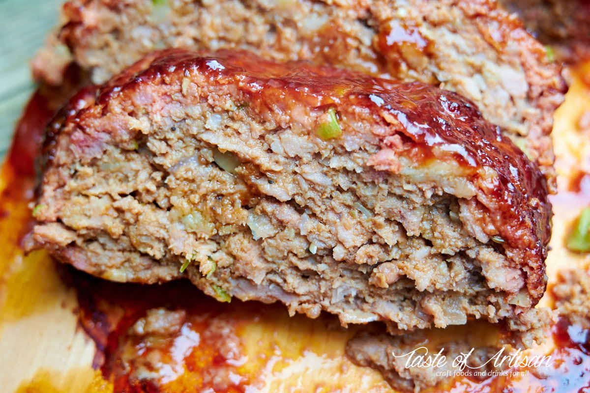 A slice of smoked meatloaf on a cedar plank.