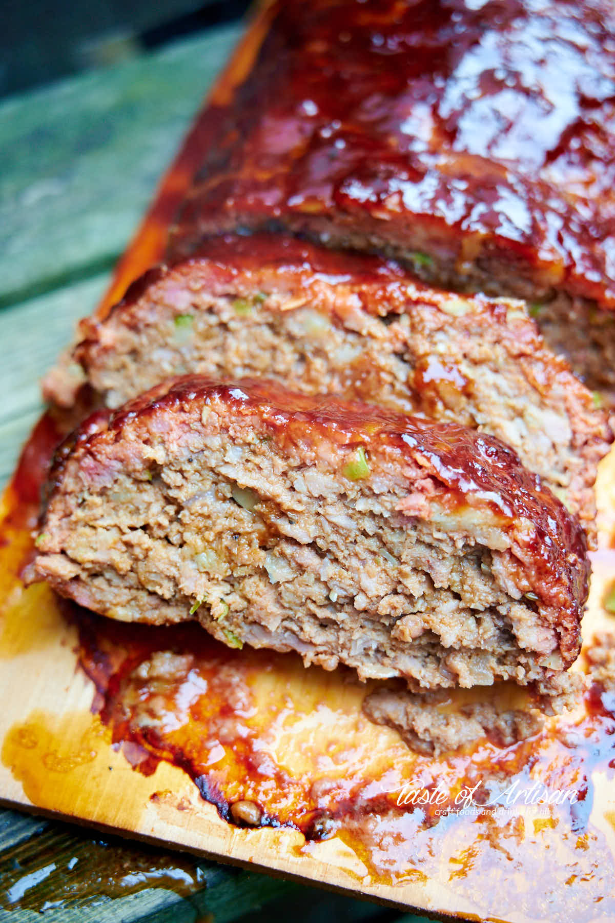 Slice meatloaf on a wooden board.