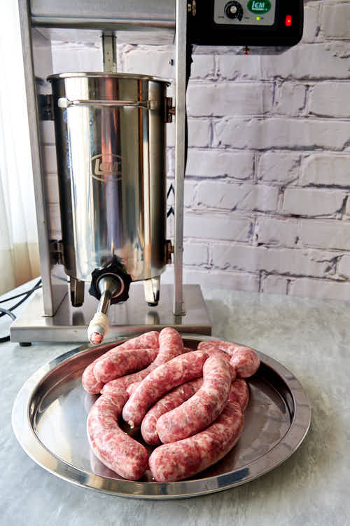 Stuffing Italian sausage into hog casings.