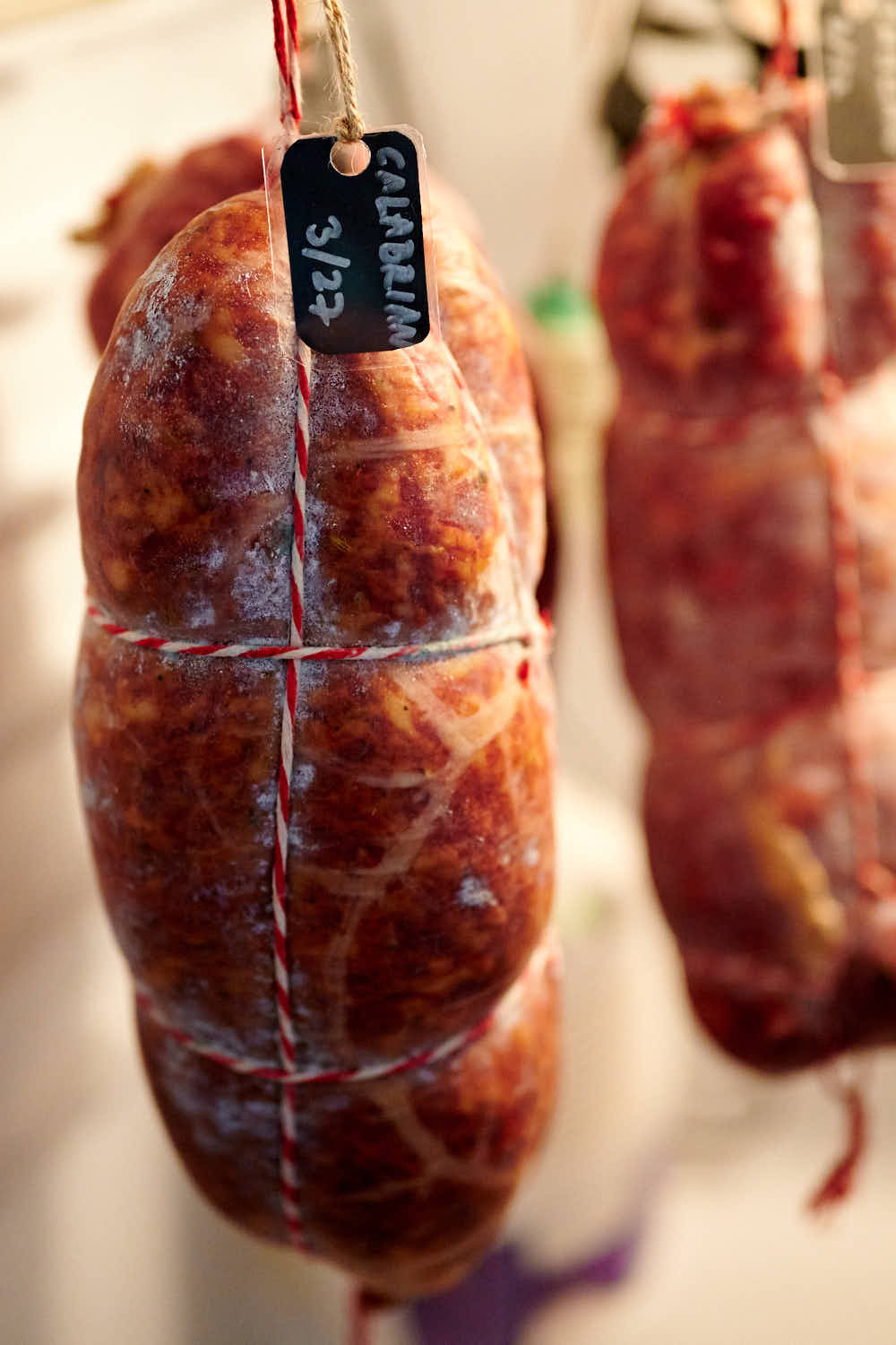 Calabrese salami curing in a meat curing chamber