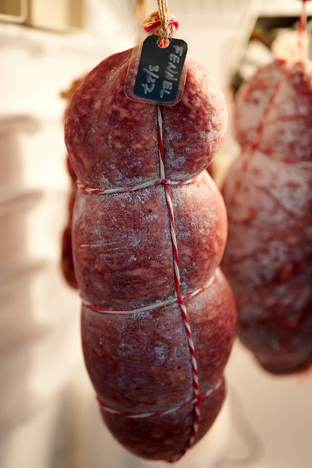 Fennel salami curing in a meat curing chamber