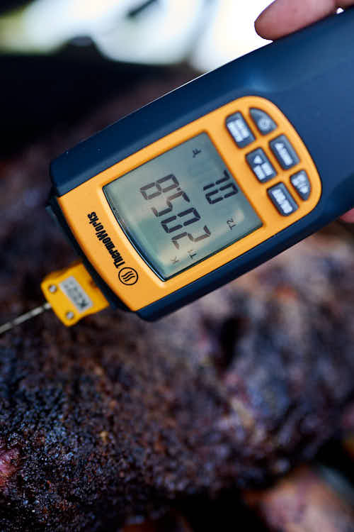 Checking beef short rib temperature with a thermometer.