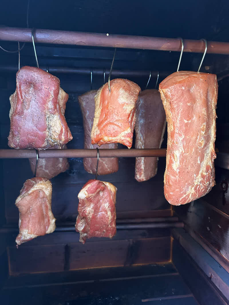 Smoking pork loins in a smokehouse.