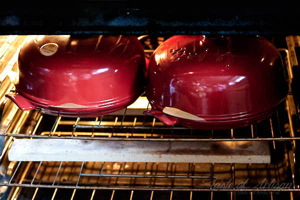 Two bread cloches in the oven.