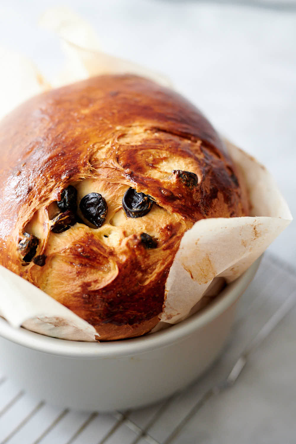 Panettone in a pan lined with parchment paper.
