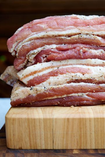 A stack of cured bacon slabs.